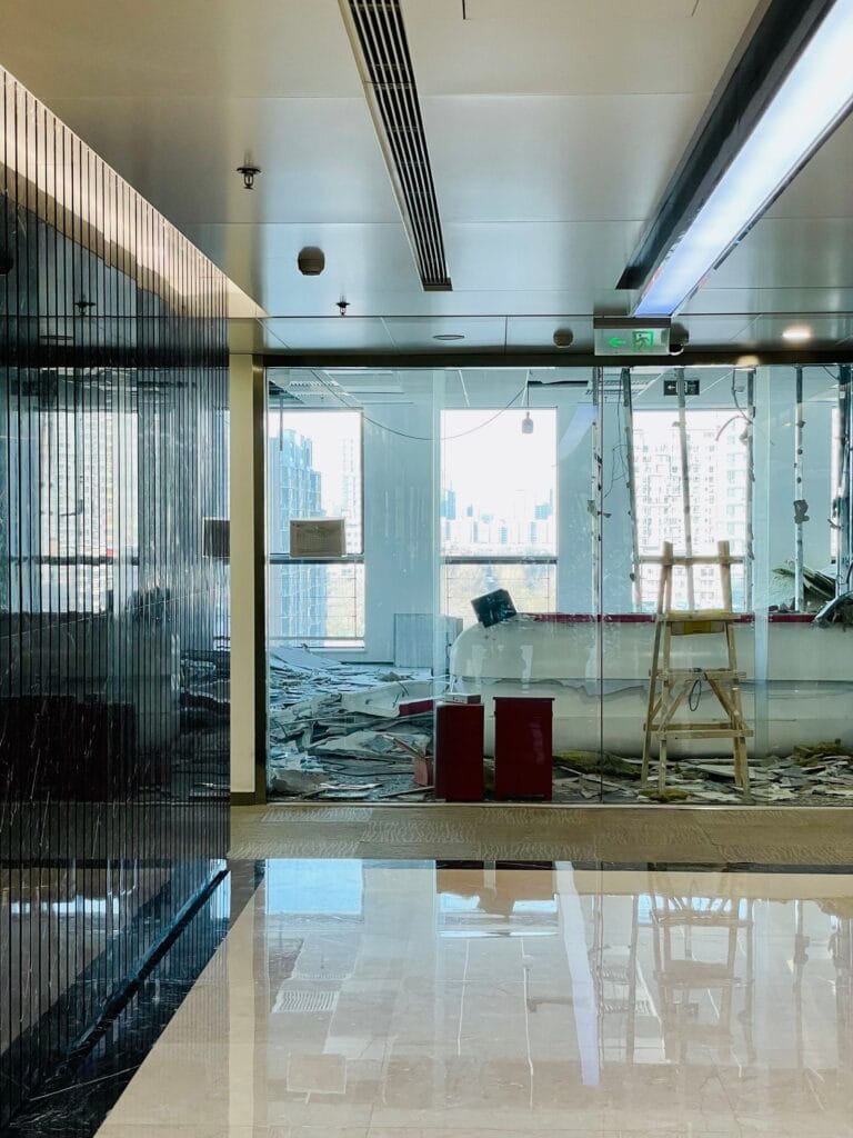 Illustrative library photograph, not an Elbaz project: a bright commercial interior mid-renovation with a city view