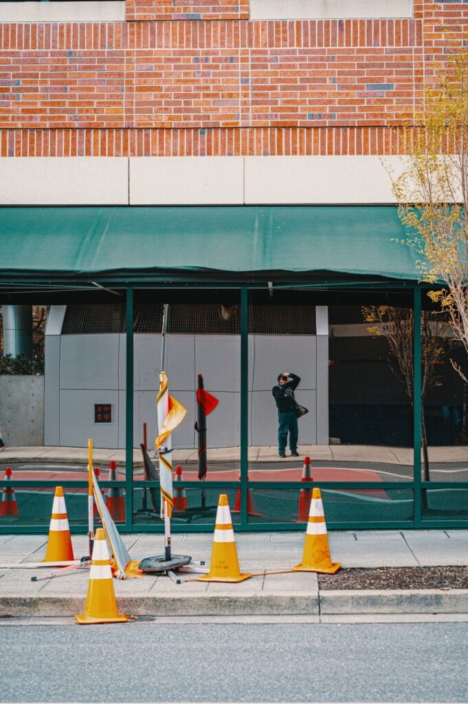 Illustrative library photograph, not an Elbaz project: a commercial storefront behind hoarding during works