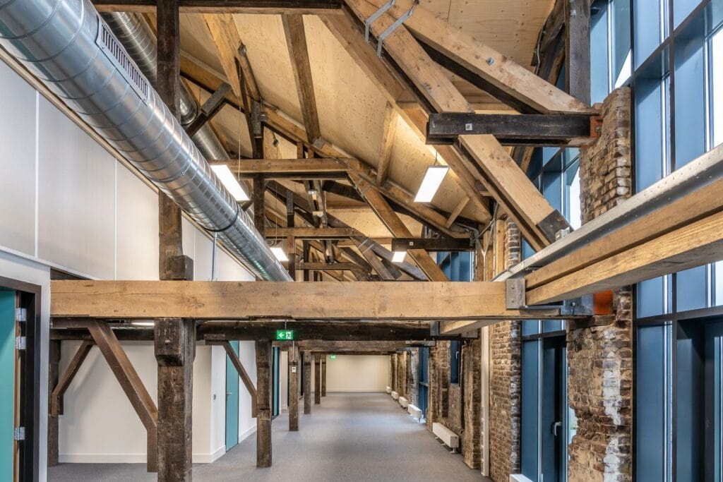 Illustrative library photograph, not an Elbaz project: a renovated commercial interior with an exposed timber roof structure