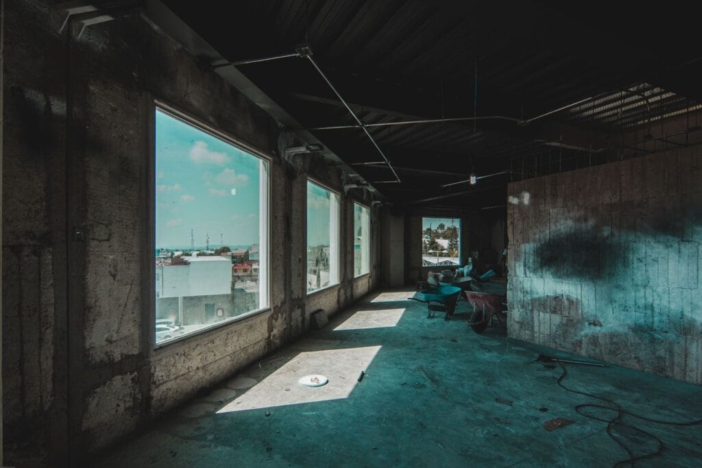 Illustrative library photograph, not an Elbaz project: a stripped commercial floor with the window line open to daylight