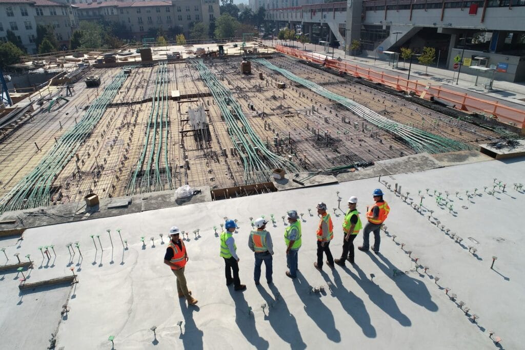Illustrative library photograph, not an Elbaz project: a team of construction workers on a commercial site