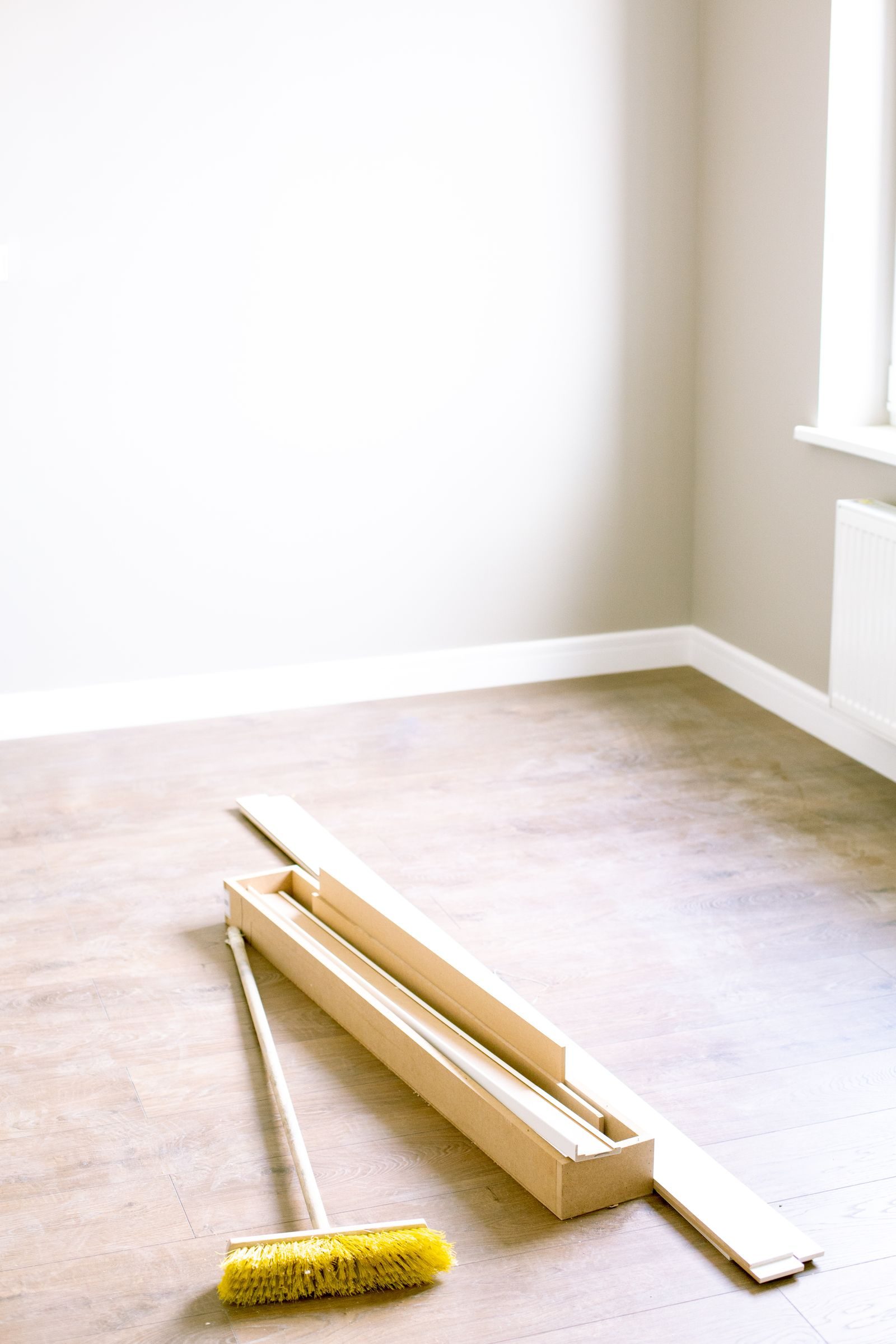Room prepped for flooring installation with unopened plank boxes
