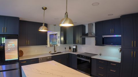 Renovated navy and brass kitchen by Elbaz Construction