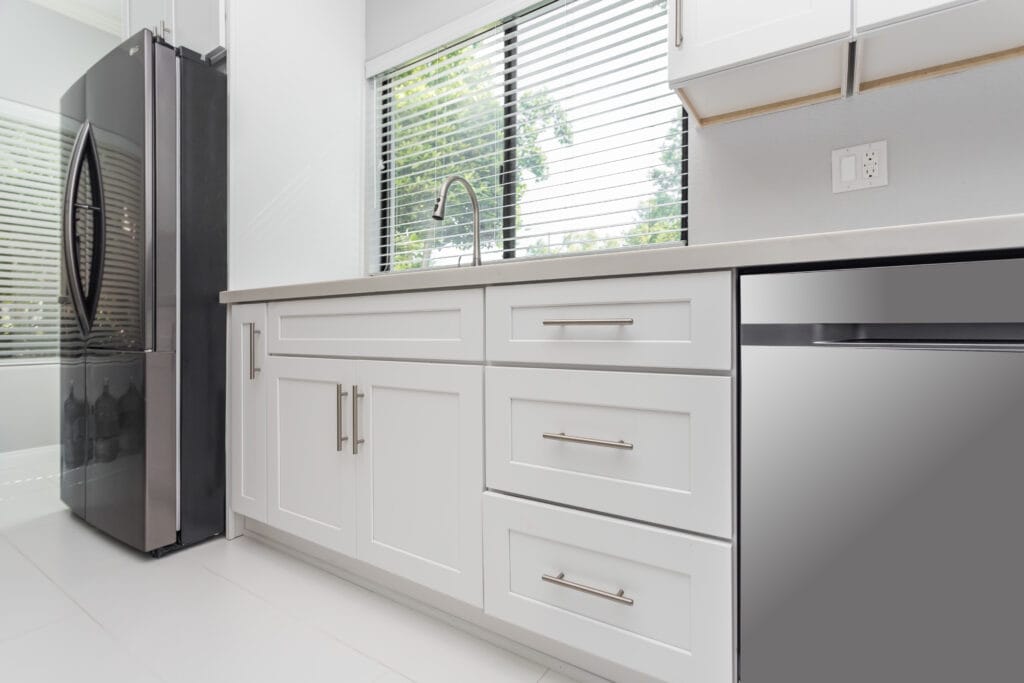 White shaker kitchen with quartz waterfall island and brushed-nickel hardware — view 8