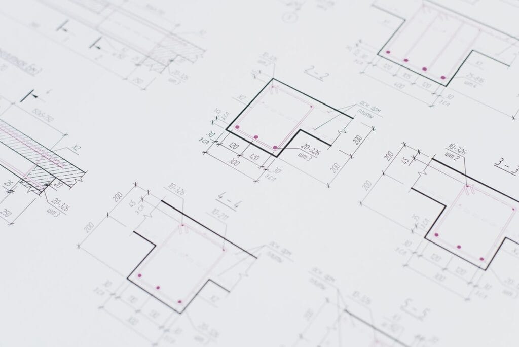 Illustrative library photograph, not an Elbaz project: a close view of structural reinforcement detail drawings