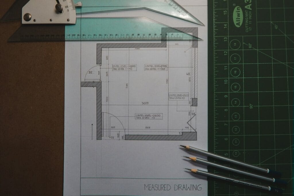 Illustrative library photograph, not an Elbaz project: a macro view of a measured architectural drawing with scale rules