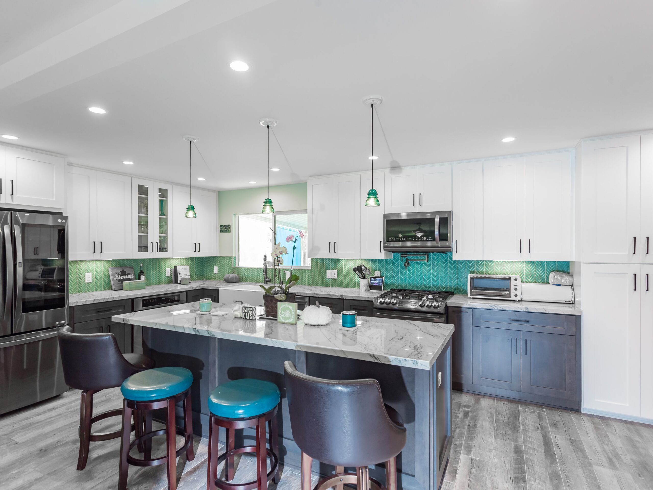 Kitchen island seen along its length with bar seating and a panelled finished end