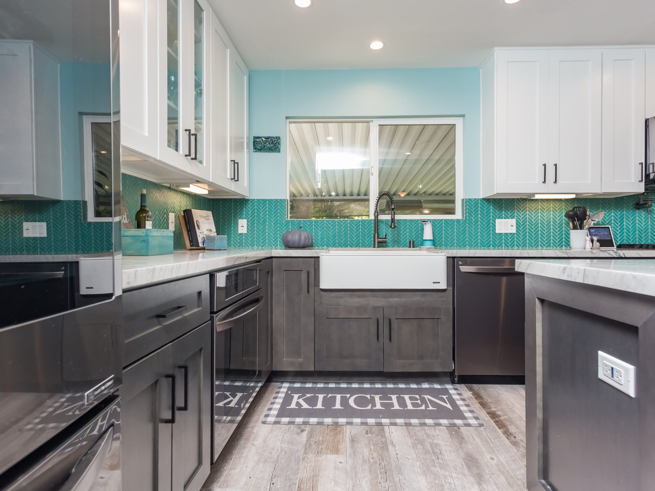 Perimeter cabinetry running under a window with drawer banks below the worktop