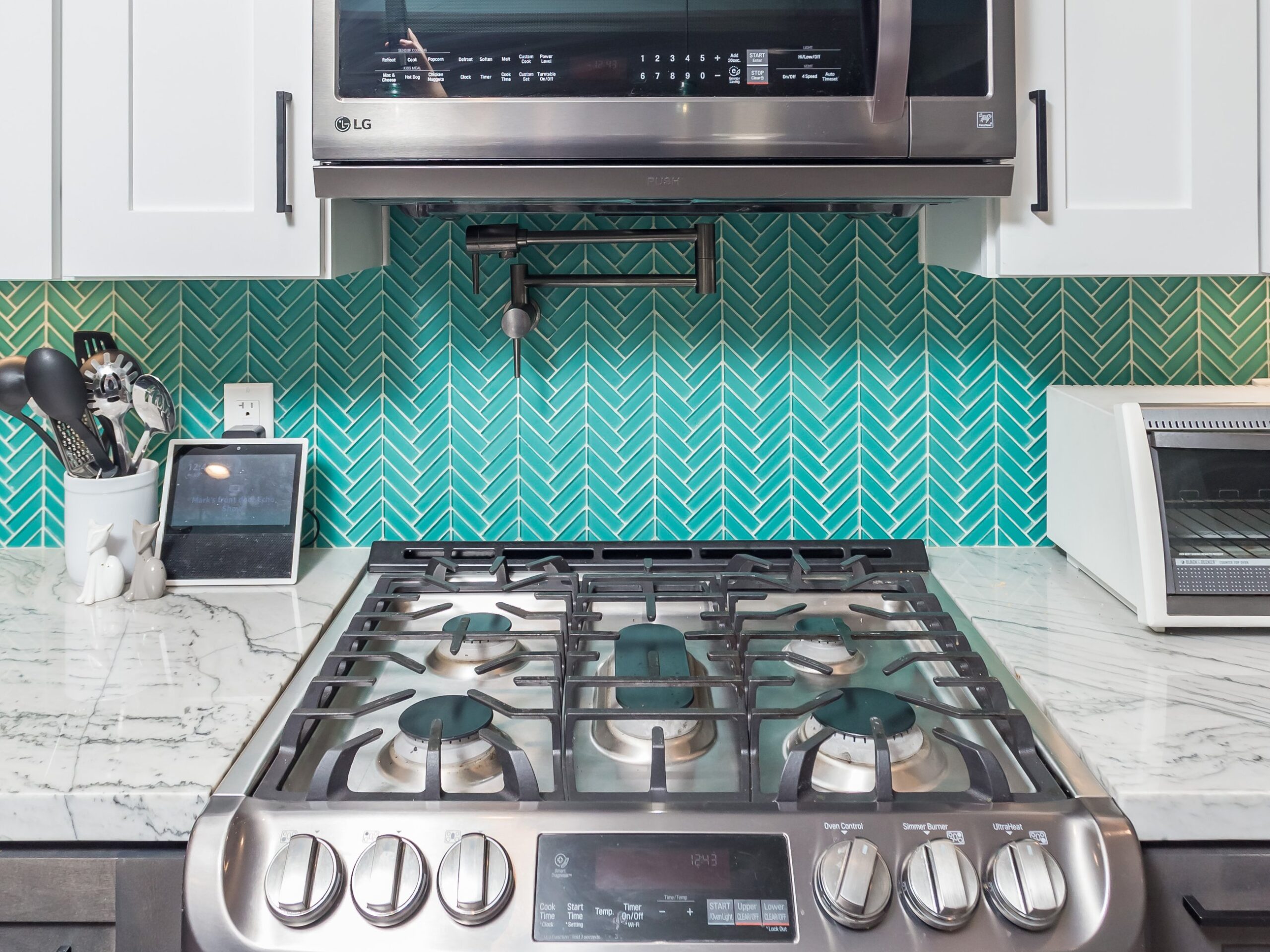 Gas range and the cabinetry either side of it, with the backsplash behind
