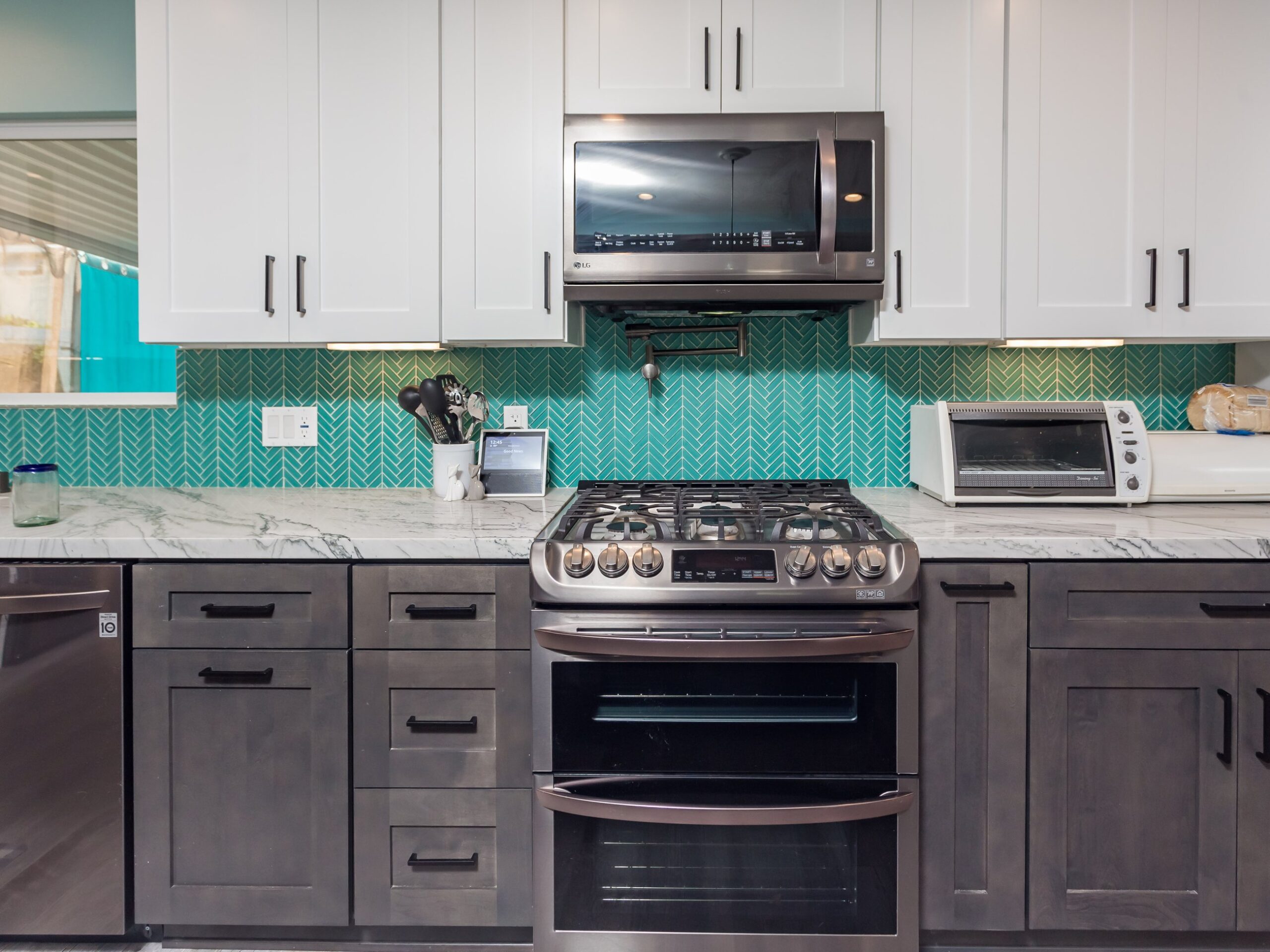 Range set between stained base cabinets with the herringbone backsplash carried full height behind it