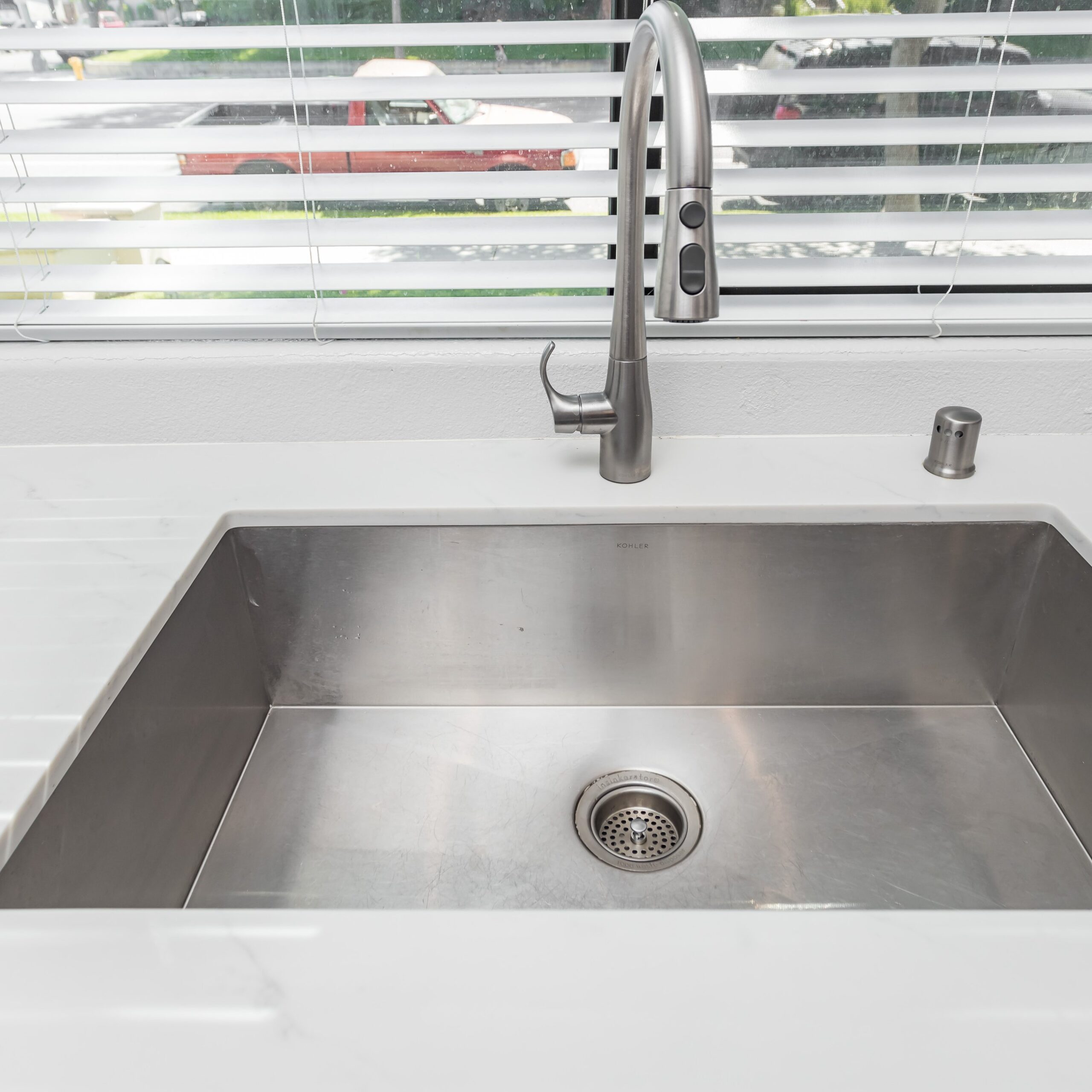 Undermount stainless sink set into a pale quartz worktop
