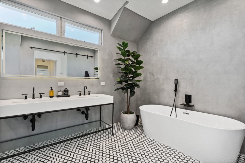 Freestanding tub against the plaster-finish wall