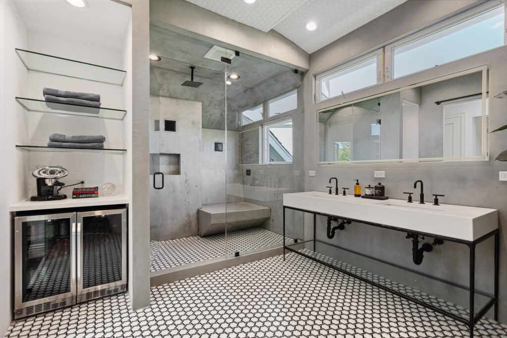 Shower alongside the vanity, with open shelving between them