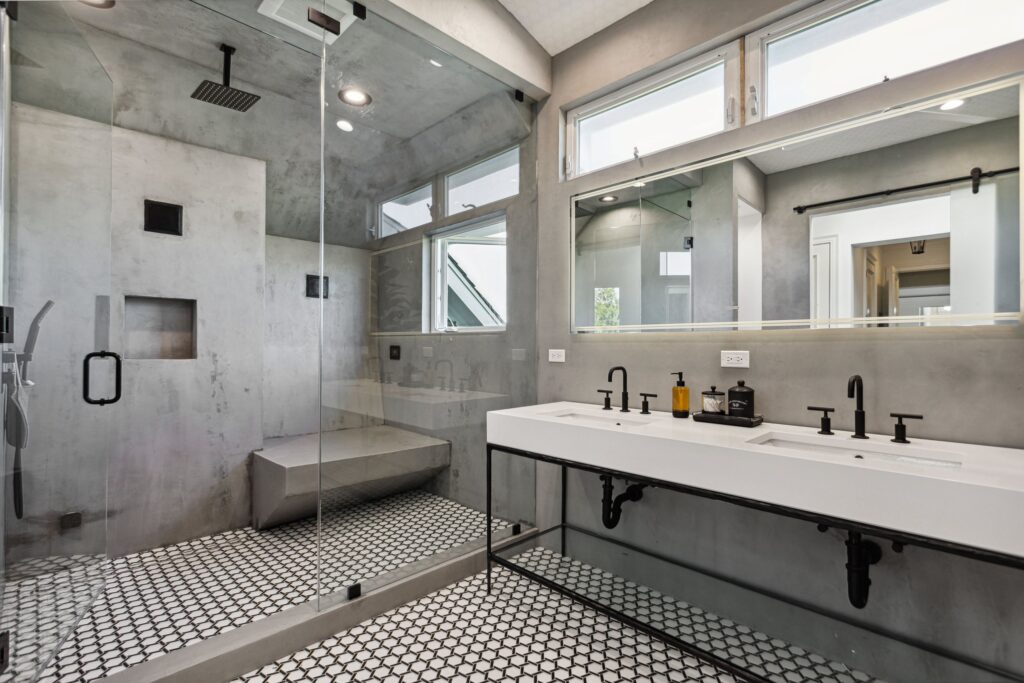 Frameless glazed shower with a formed bench and recessed niches