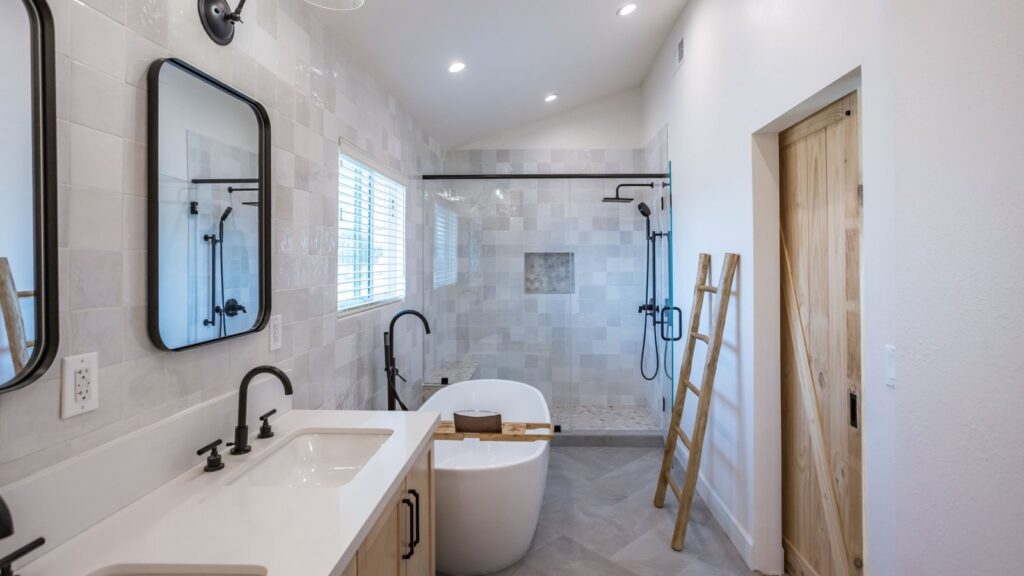 Completed primary bath suite with a double vanity, freestanding tub and glazed walk-in shower