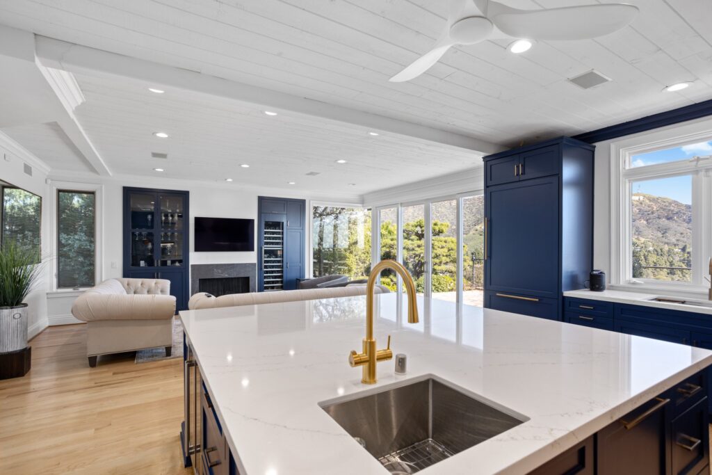 Long island with an undermount sink and brass tapware, open to the living space