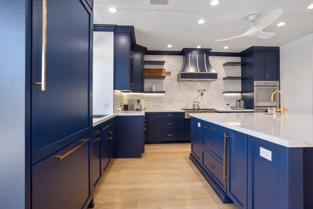 Perimeter cabinetry with integrated appliances and open timber shelving