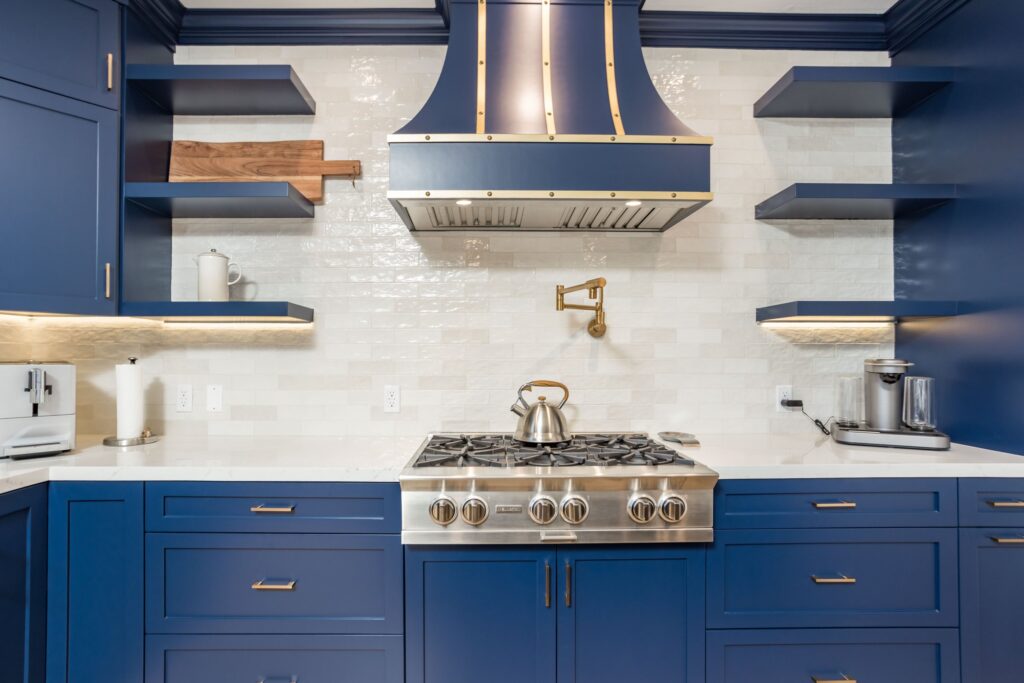 Custom hood flanked by floating timber shelves above the splashback