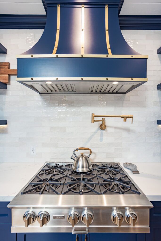 Professional range under the brass-strapped custom hood