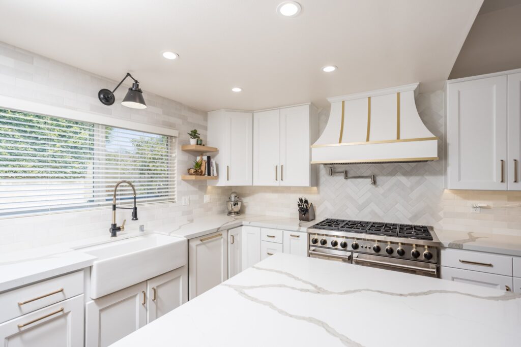Farmhouse sink under the window with the range wall beyond