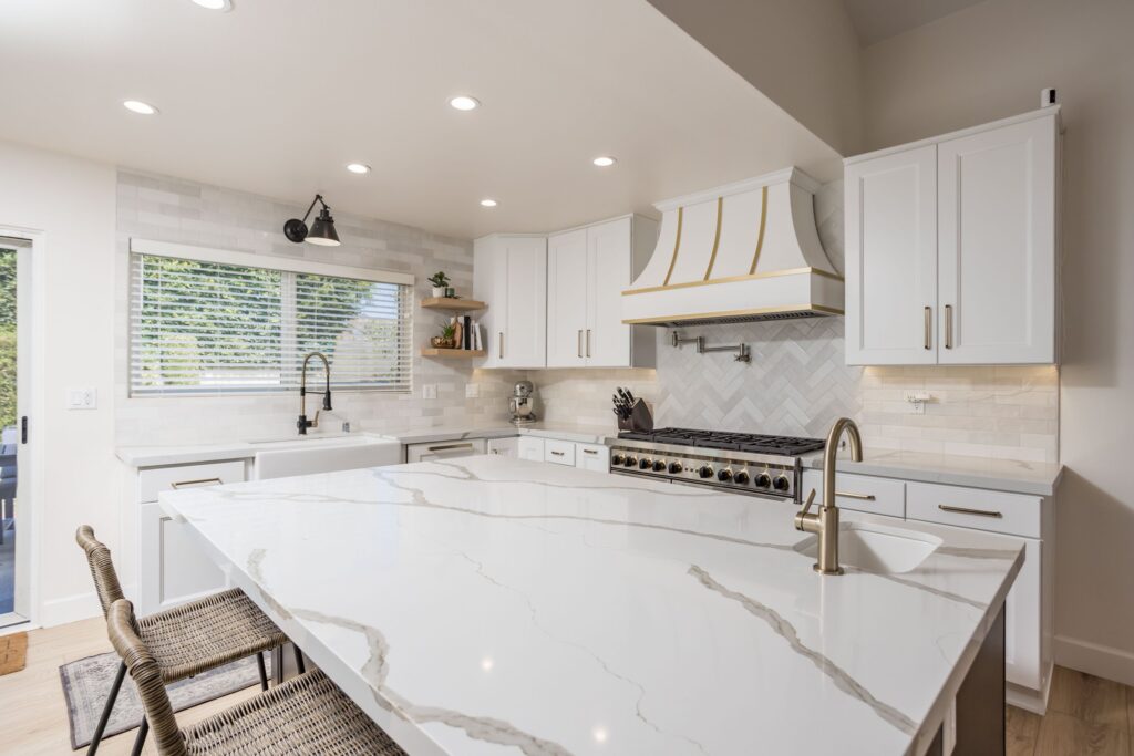 Island worktop in a marble-look stone with a waterfall end