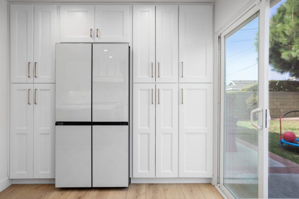 Integrated refrigeration flanked by full-height pantry doors