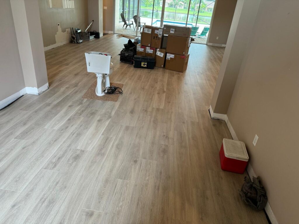 Wide-plank floor in an unfurnished room, showing the run direction