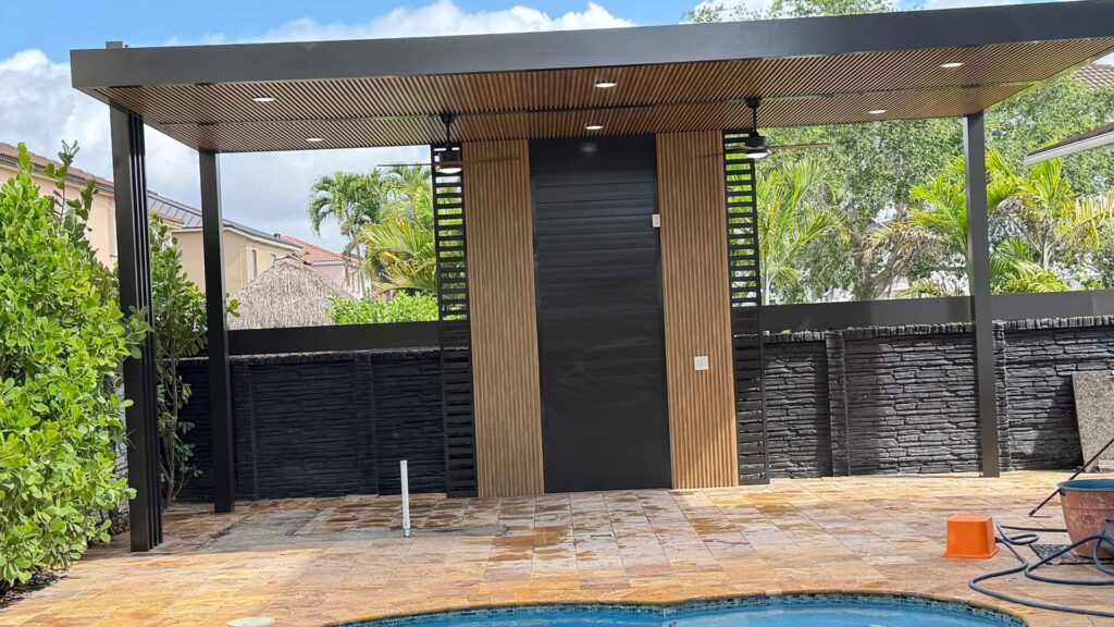 Covered terrace with a timber soffit over a paved deck, completed by Elbaz Construction in South Florida