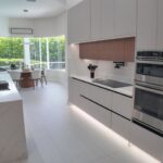Kitchen island looking through to the screened lanai and rear glazing