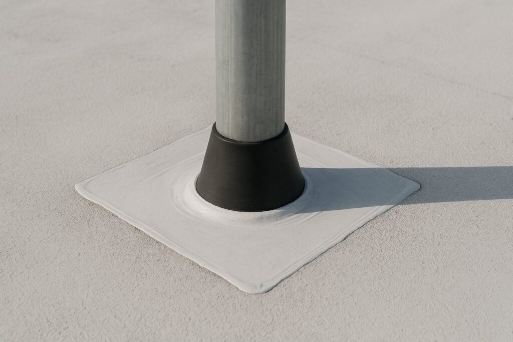 Illustrative, AI-generated: a pipe penetration through a flat roof with a sealed collar and reinforcing patch