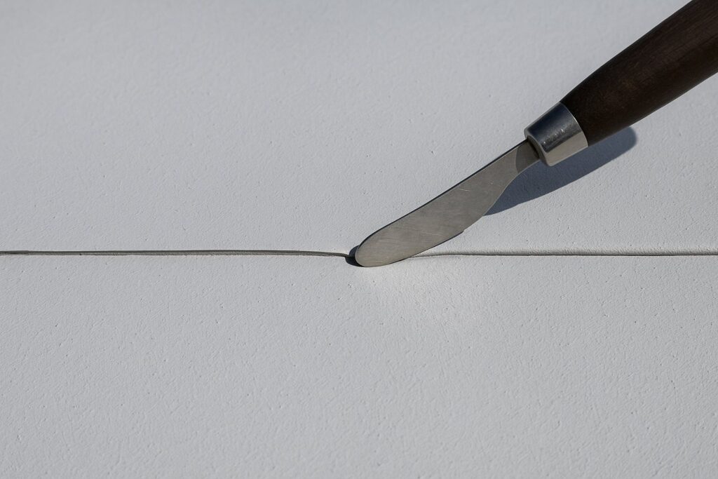 Illustrative, AI-generated: a lap seam on a roof membrane being probed to check the bond