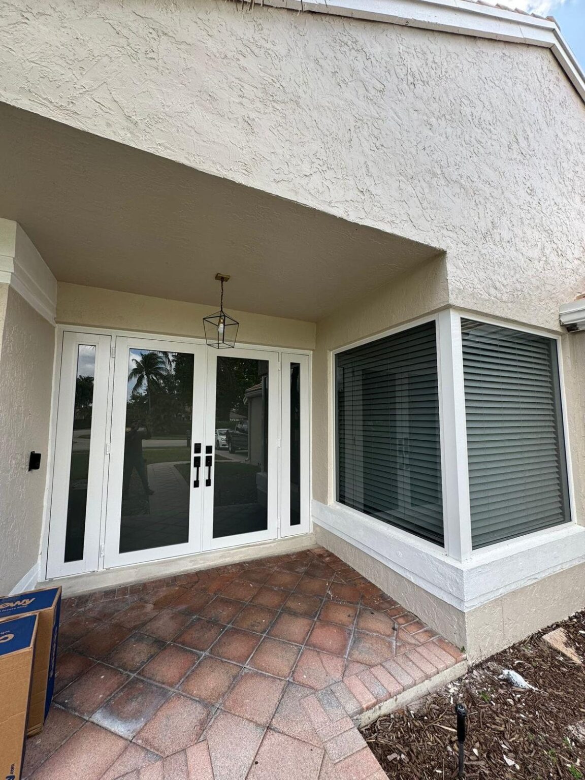 Elbaz installation: impact window run and glazed french doors under a covered entry