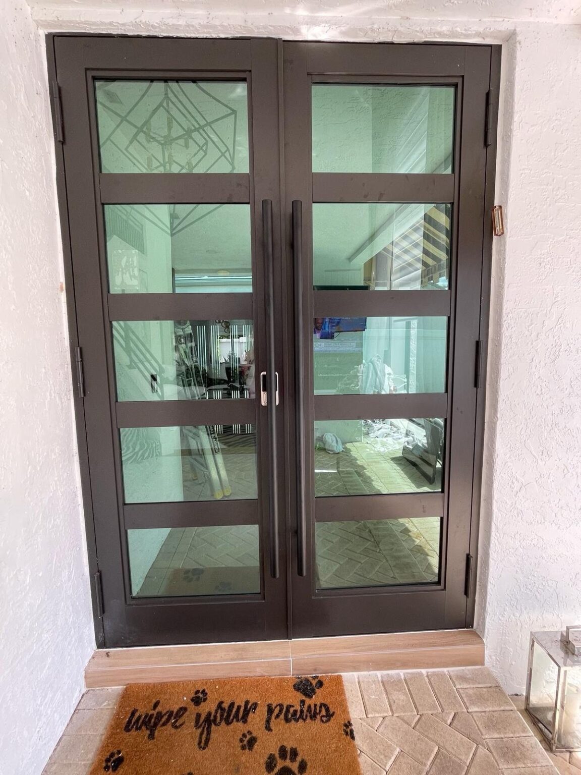 Elbaz installation: glazed impact entry doors in a dark bronze finish