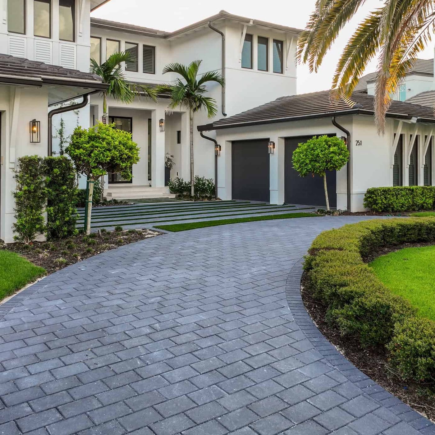 Curved paver driveway and landscaping at a modern two-storey home