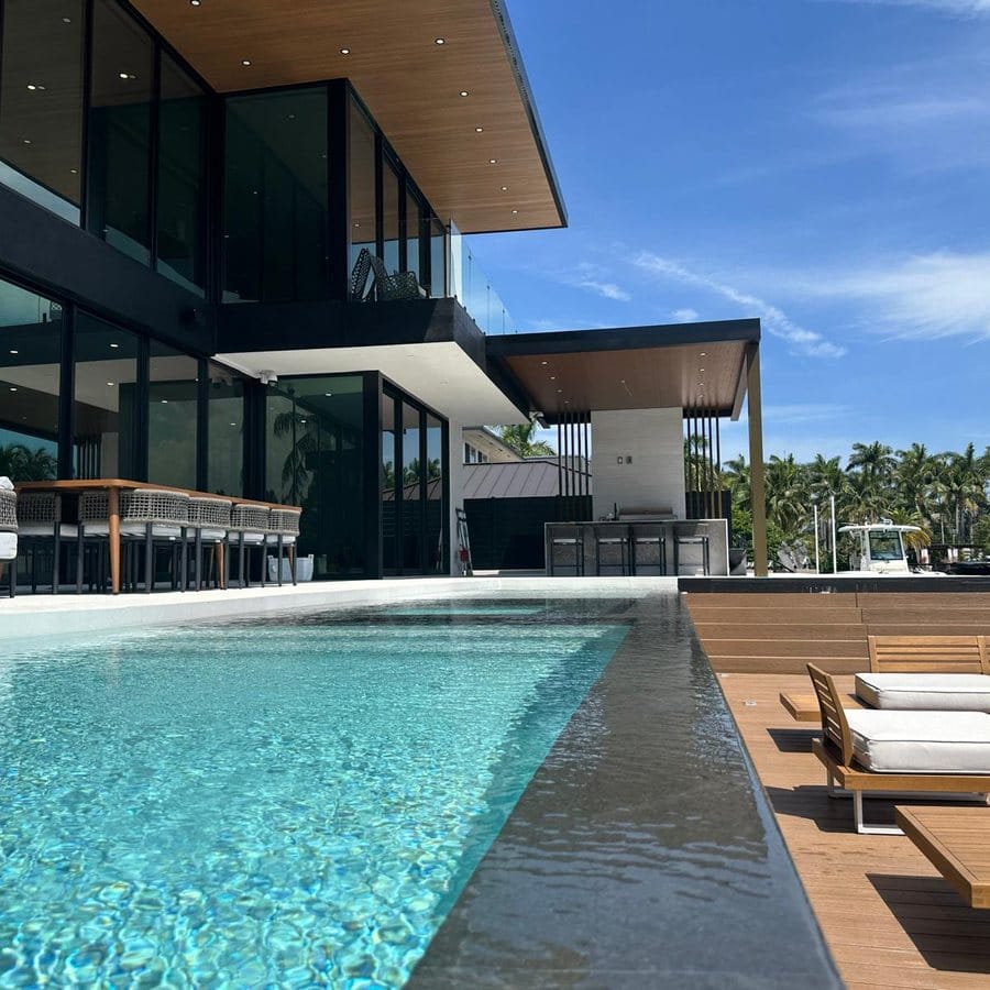 Pool deck running out to the dock edge on a South Florida canal, by Elbaz Construction