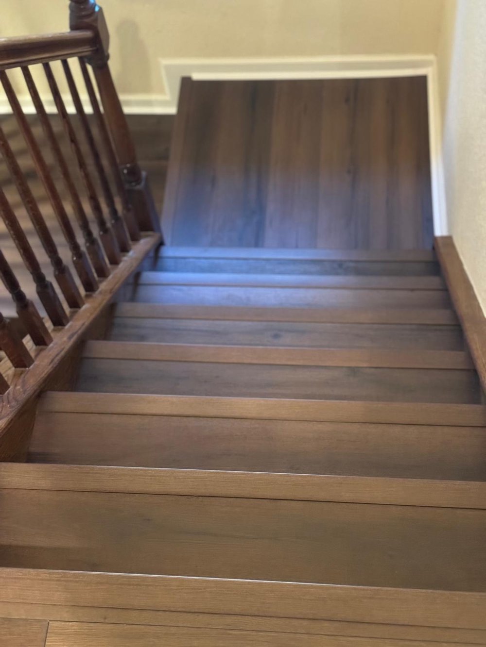 Plank flooring in a hallway leading to a bedroom
