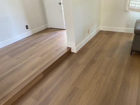 Timber stair treads and balustrade above a tiled landing