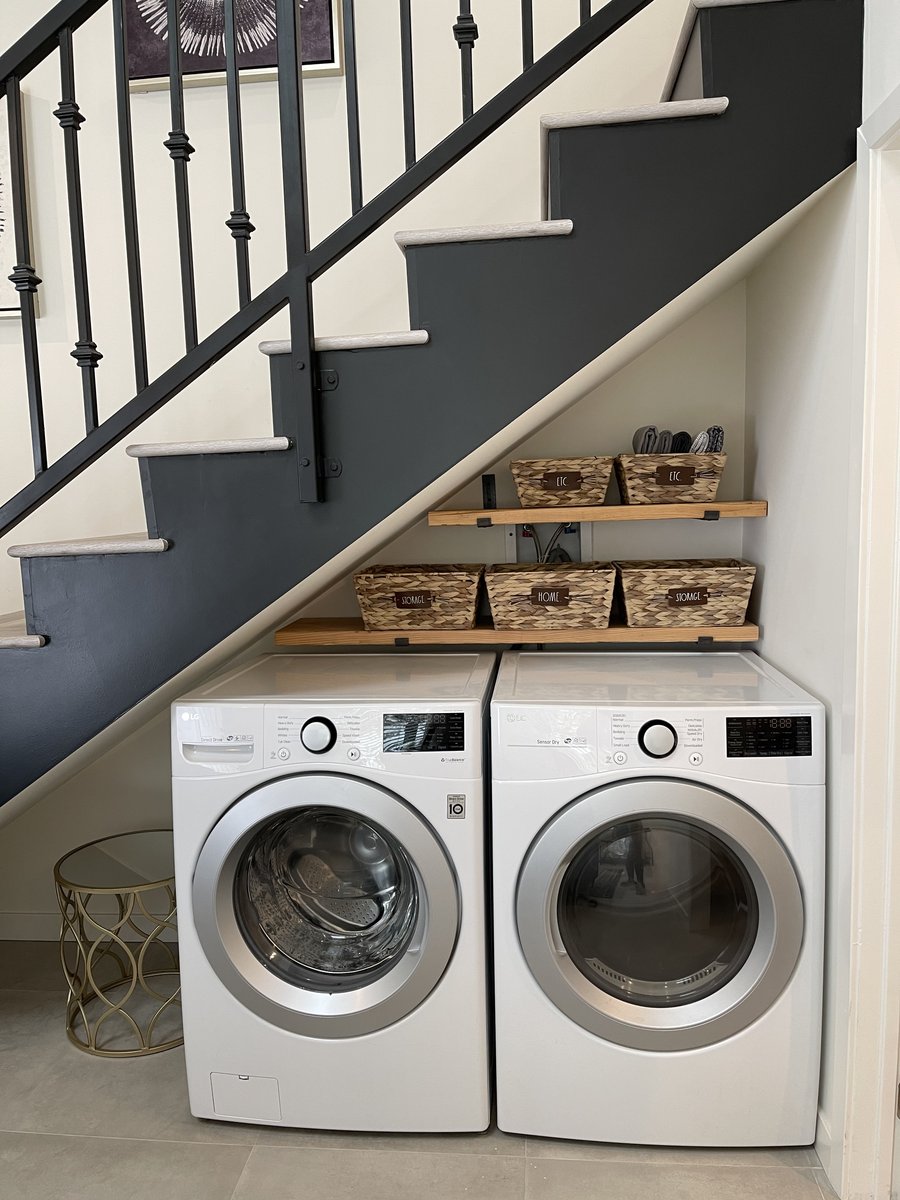 Stair to the loft level of an accessory dwelling unit with laundry built into the space beneath it
