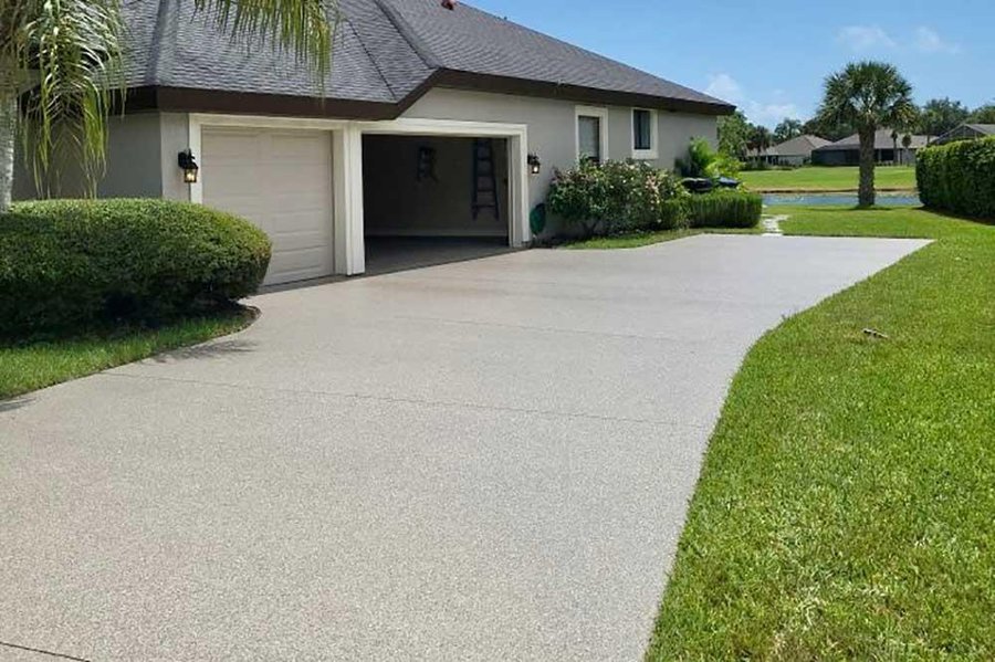 Plain poured concrete driveway with a broom finish and cut control joints