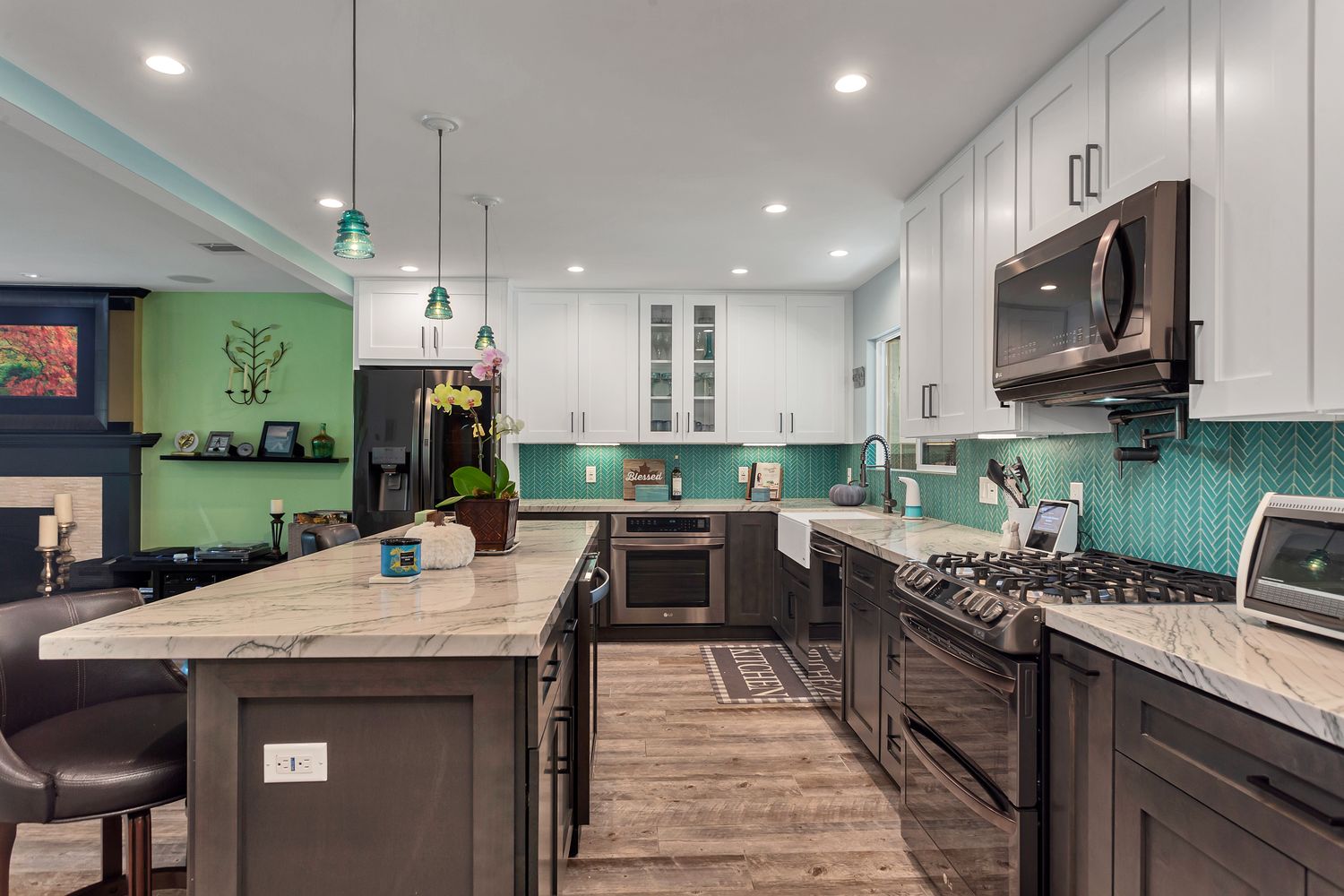 Gas cooktop set into a marble kitchen island top, with the seating kept clear on the far side