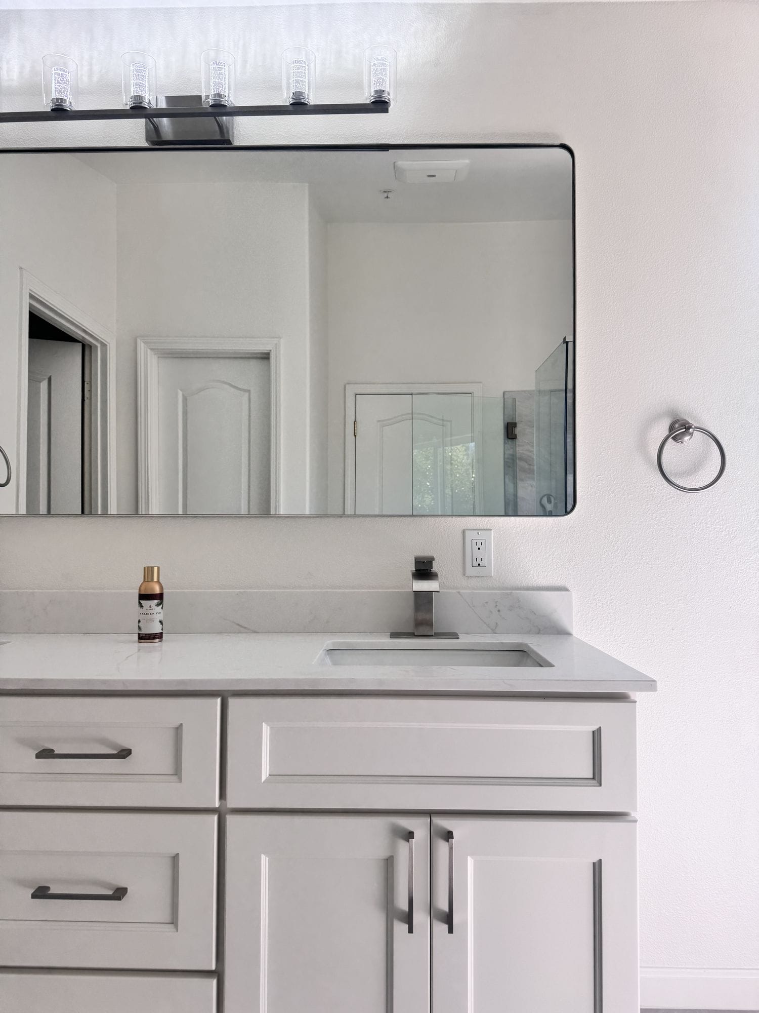 White shaker vanity with a quartz top, undermount basin and brushed nickel tap