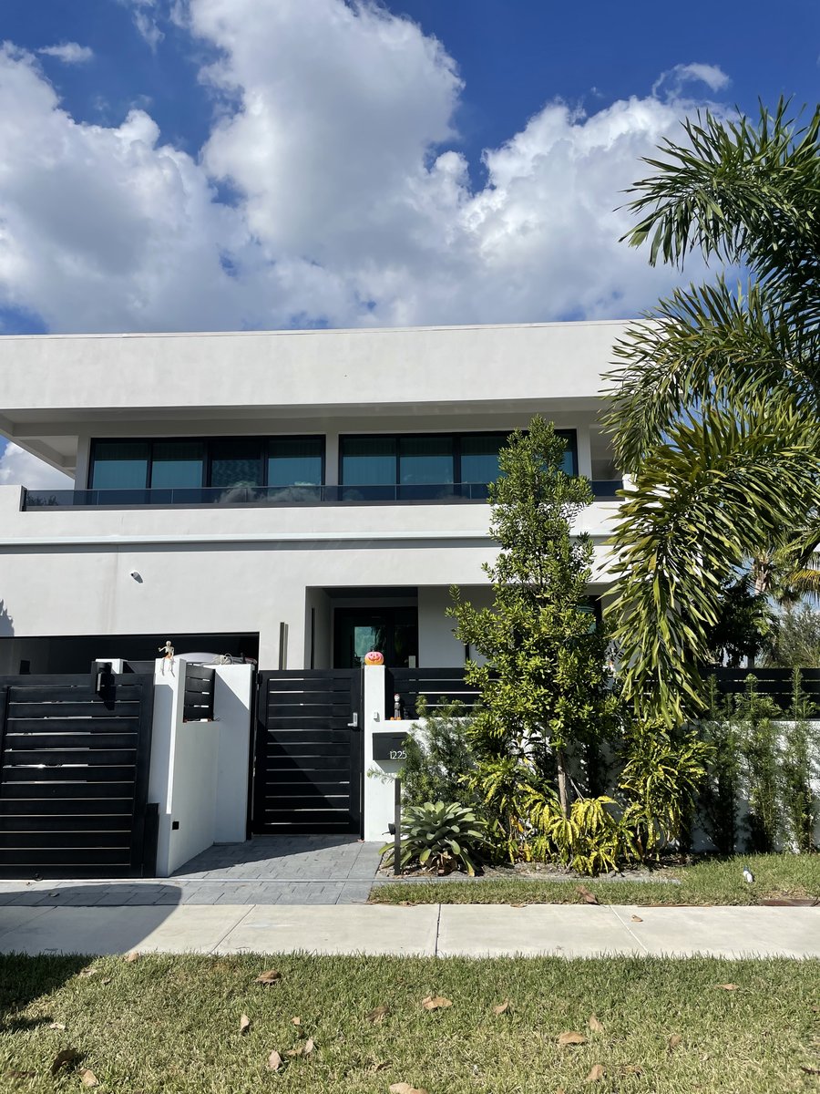 Modern elevation with dark-framed impact windows and a recessed entrance