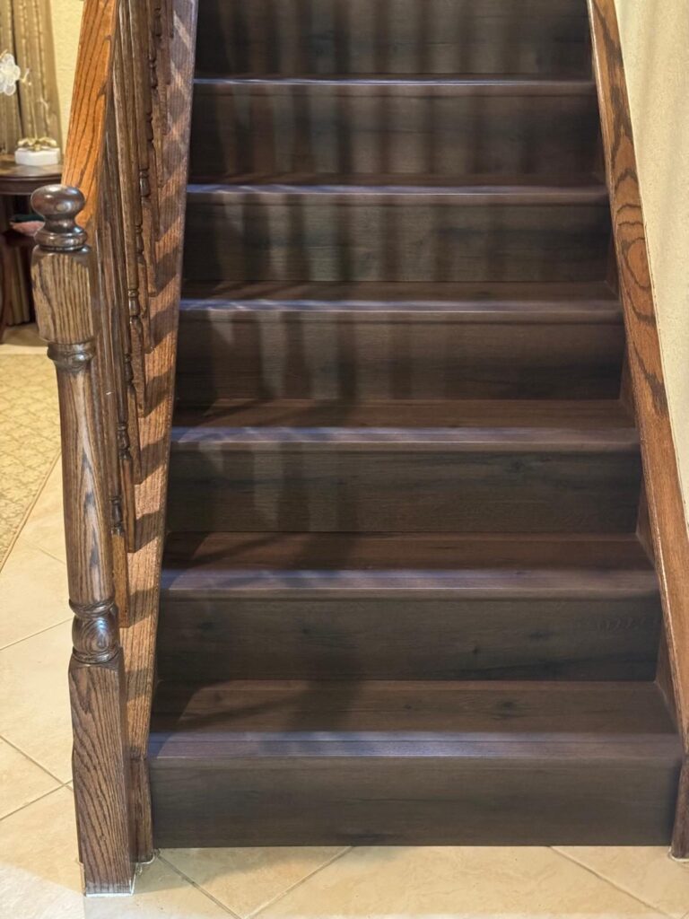 Stained timber stair treads and risers with turned balusters and a matching handrail