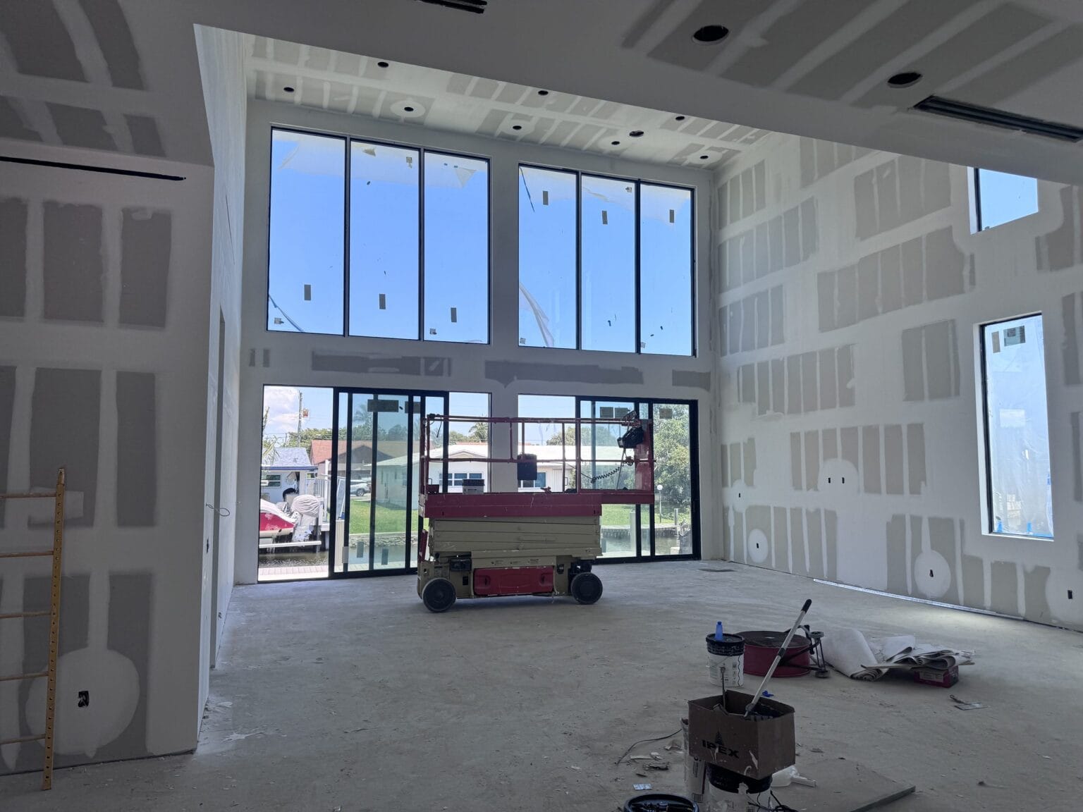 The same room looking up at the ceiling soffit, with services run and boarding complete before finishes