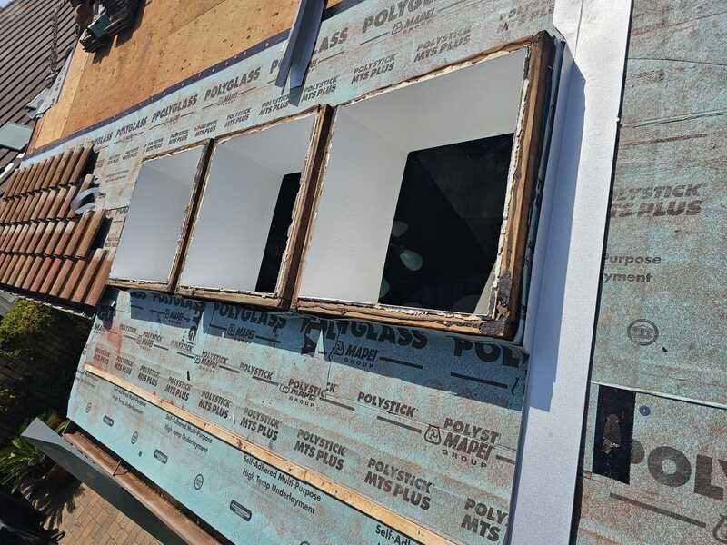 Self-adhered SBS-modified underlayment lapped across a roof deck and turned up at a skylight curb before tile is installed