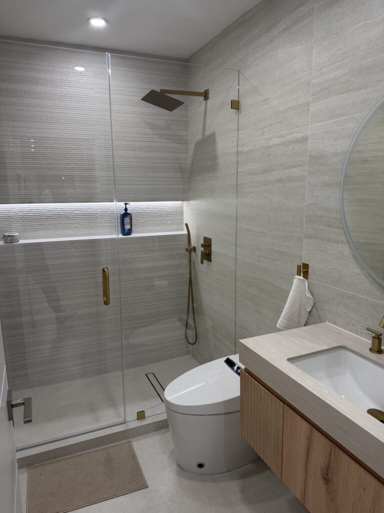 Bathroom with the walk-in shower on the left and a timber vanity and basin alongside