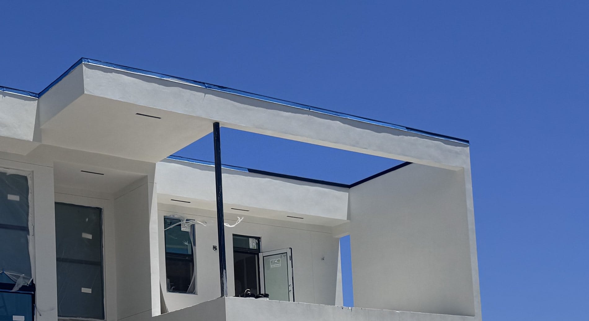 Close-up of the cantilevered terrace soffit, its recessed lighting cans and the steel column