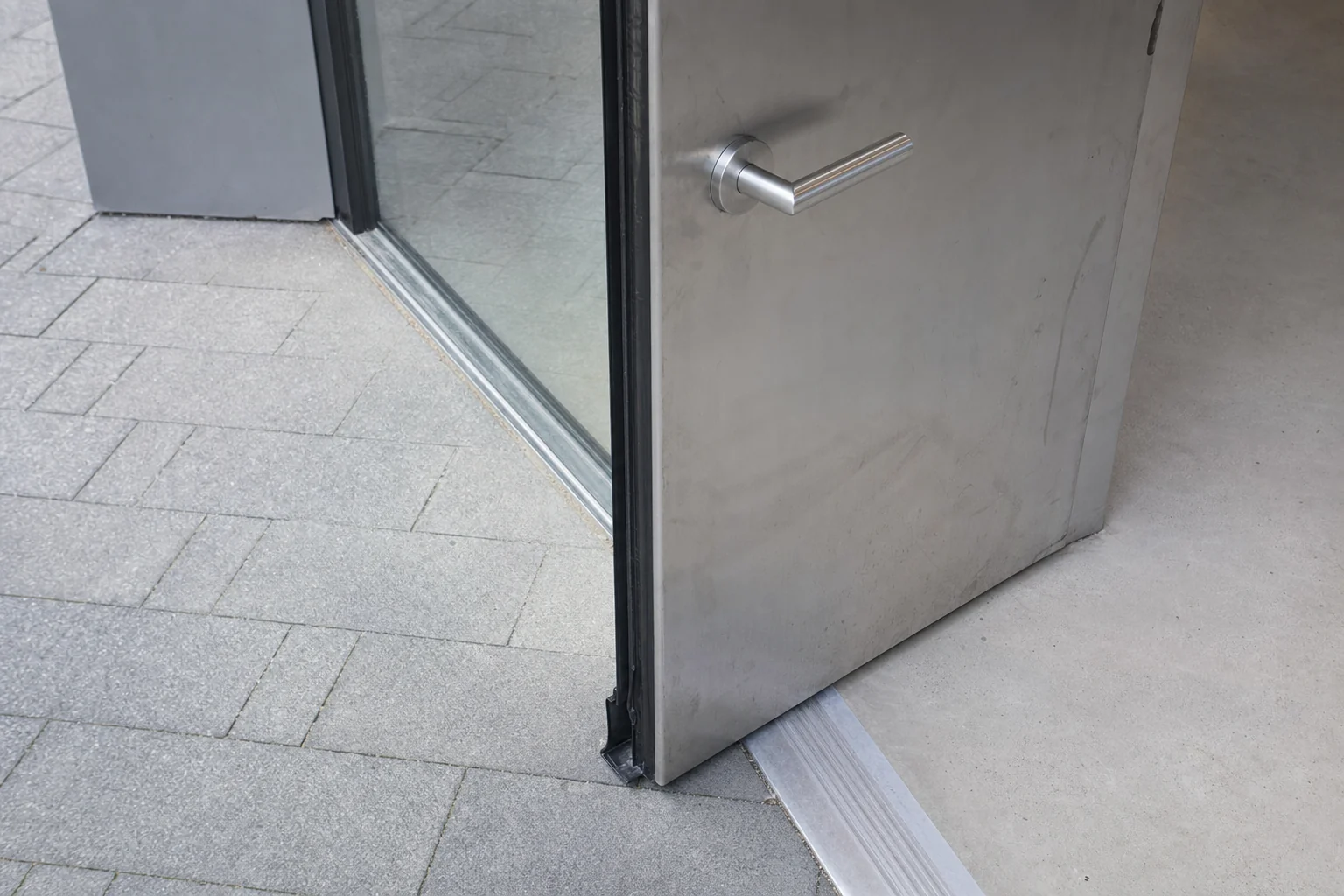 Lever door hardware and low bevelled threshold at an accessible entrance