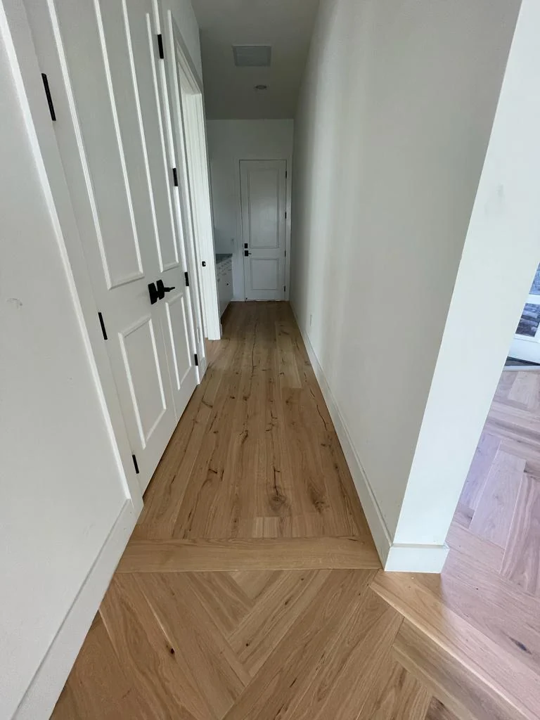 Herringbone flooring laid down a hallway