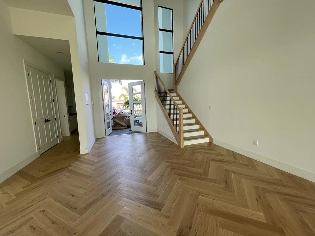 Herringbone flooring running to a stair landing